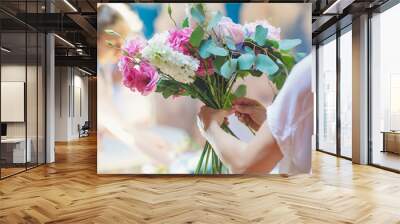 Hands of florist woman creating bouquets for wedding decoration Wall mural