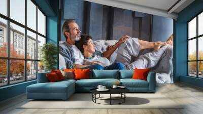 aged couple sitting on the couch Wall mural