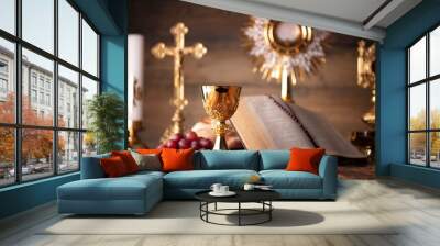 Catholic religion concept. Catholic symbols composition. The Cross, Holy Bible, rosary and golden chalice on the altar. Wall mural