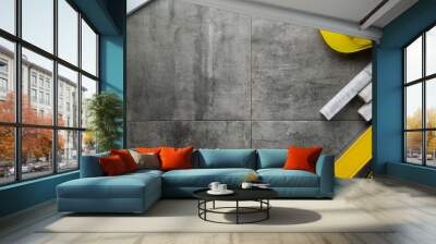 Contractor concept. Yellow hardhat, libella and plans on the gray tiles. Wall mural