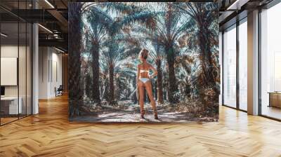 beautiful young woman in white bikini on tropical nature background Wall mural