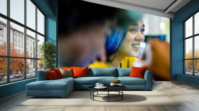 Modern blue hair woman smiling.Group of multiethnic people having business team meeting in restaurant lounge.Teamwork,corporate,diversity and social concepts. Wall mural