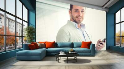 smiling young casual businessman talking on the phone at office Wall mural