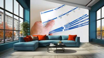 man with pay checks in hand isolated on white Wall mural