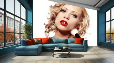 beautiful blond woman applying makeup on her face Wall mural