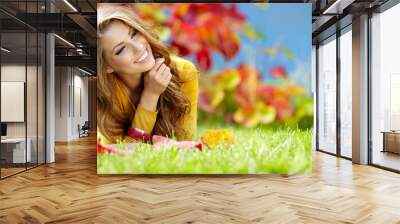 beautiful girl with book in the autumn park Wall mural