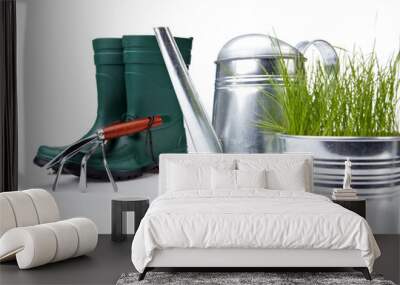 Garden tools and watering can with grass on white Wall mural