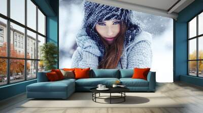 Girl playing with snow in park Wall mural