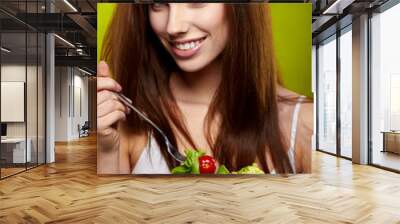 Healthy lifestyle - woman holding vegetable salad on green backg Wall mural