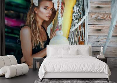 Surfer woman posing with surfboard. Wall mural