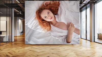 very sensual woman in sexy pose on bed with long natural redhair, open shirt and white panties Wall mural