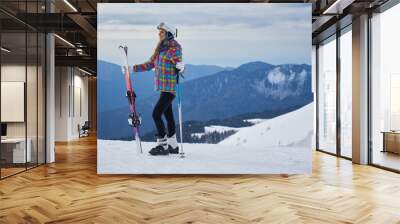 woman skier  wearing white healmet with mask in snow winter mountain Wall mural