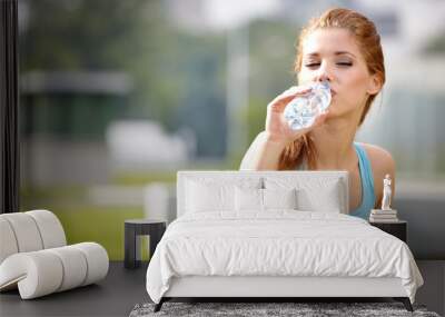 young beautiful woman drinking water after fitness exercise outd Wall mural