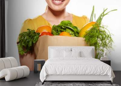 Young woman with a grocery shopping bag. Isolated on white backg Wall mural