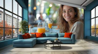 a beautiful girl having breakfast and an orange juice Wall mural