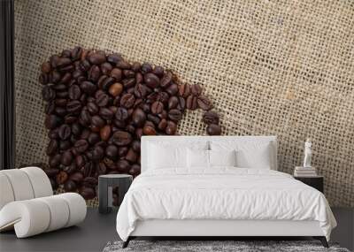 Roasted coffee beans placed in the shape of a cup and placed on sackclothe Wall mural