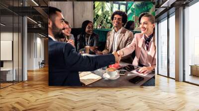 Group of business people having meeting in cafe. Wall mural