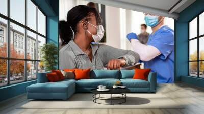 Male nurse with mask greeting with patient in clinic.	 Wall mural