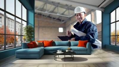 Senior construction manager controlling building site. Wall mural