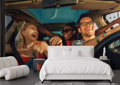 Three best friends enjoying traveling at vacation in the car. Wall mural