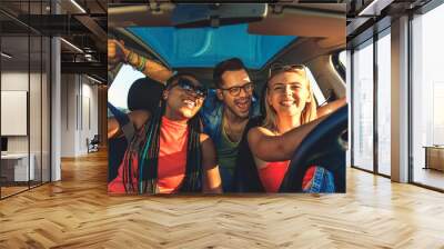 Three best friends enjoying traveling at vacation in the car. Wall mural