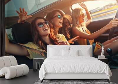 Three female friends enjoying road trip traveling at vacation in the car. Wall mural