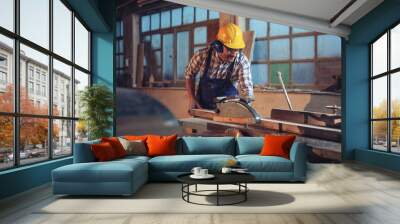 Carpenter working with circular saw at carpentry workshop  Wall mural