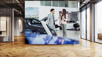 Customer buying a vehicle at car dealership Wall mural