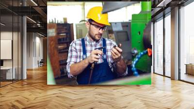 Modern industrial machine operator working in factory  Wall mural