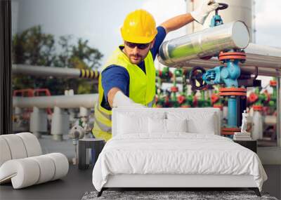 Oil worker closes the valve on the oil pipeline Wall mural