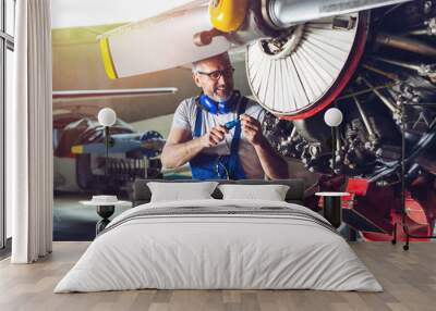 Plane Maintenance Engineer Repairing Engine  Wall mural