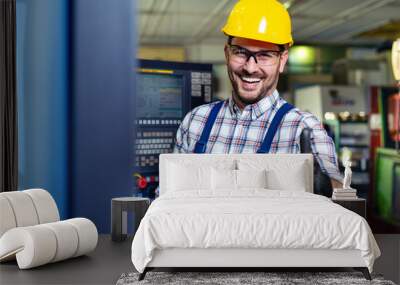 Portrait Of Male Engineer Operating CNC Machinery In Factory  Wall mural