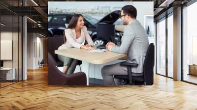 Sales manager at a showroom car is worth to the buyer Wall mural