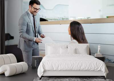 Salesperson selling cars at dealership to buyer Wall mural