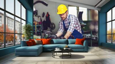 Turner worker is working on a lathe machine in a factory.   Wall mural