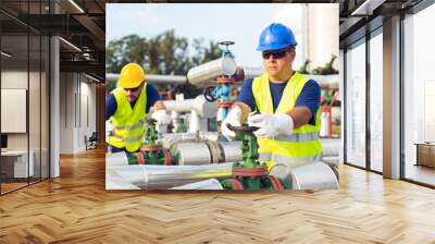 Two engineers working inside oil and gas refinery Wall mural