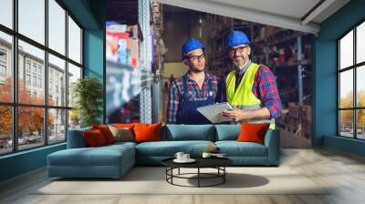 Two warehouse workers filling in document  Wall mural