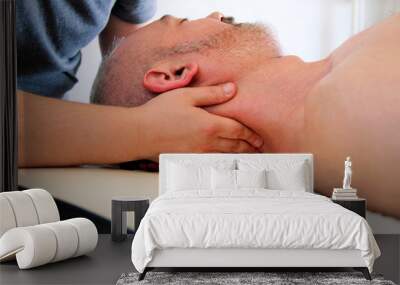 Massage relax professional wellness center. Masseuse human hands massaging for neck. Man taking a massage neck muscles at massage table. Body care. Male body massage treatment in spa studio. Wall mural