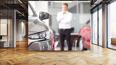 Young businessman at the car dealership Wall mural