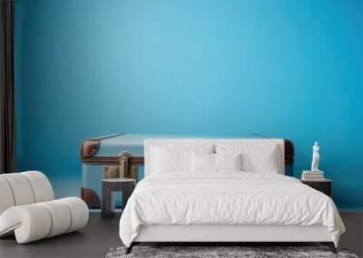 suitcase on a blue background space for text Wall mural