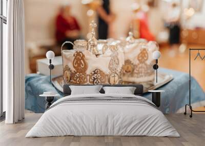 Two wedding crowns in the church. Golden crowns lie on the table in the church Wall mural