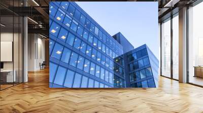 office building windows with inner artificial lamplight in blue color tone Wall mural