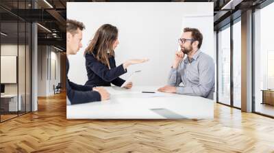 Bossy businesswoman with her colleagues sitting on a meeting in the office. Wall mural