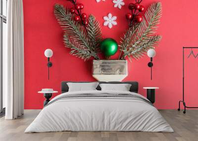 Flat lay of paint brush with christmas tree branches, bauble decoration, snowflakes and red berries minimal creative holiday concept. Wall mural