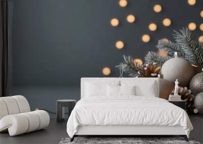 Elegant Christmas decorations with gold ornaments, pine cones, and festive lights on a dark background, creating a cozy holiday atmosphere. Wall mural