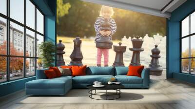 Child with huge chess figures outdoor Wall mural