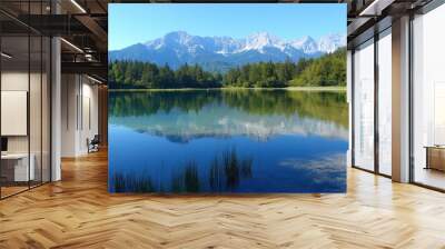 Serene alpine lake reflecting mountains and clear blue skies. Wall mural