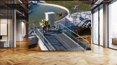 Engineers assesing waste treatment plant with drone Wall mural