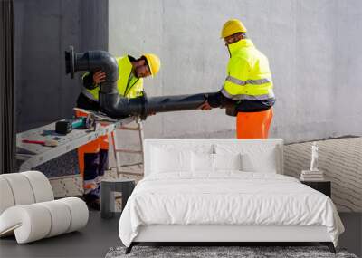 Workers assembling PVC piping Wall mural