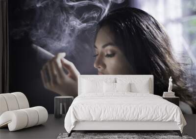 Portrait of beautiful young lady smoking cigarette . Wall mural